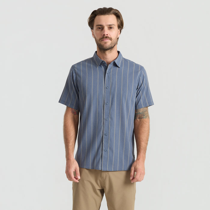 Close-up view of a stylish, rugged Roark adventure shirt featuring detailed buttons, collar, and pocket design, perfect for travel and outdoor activities.