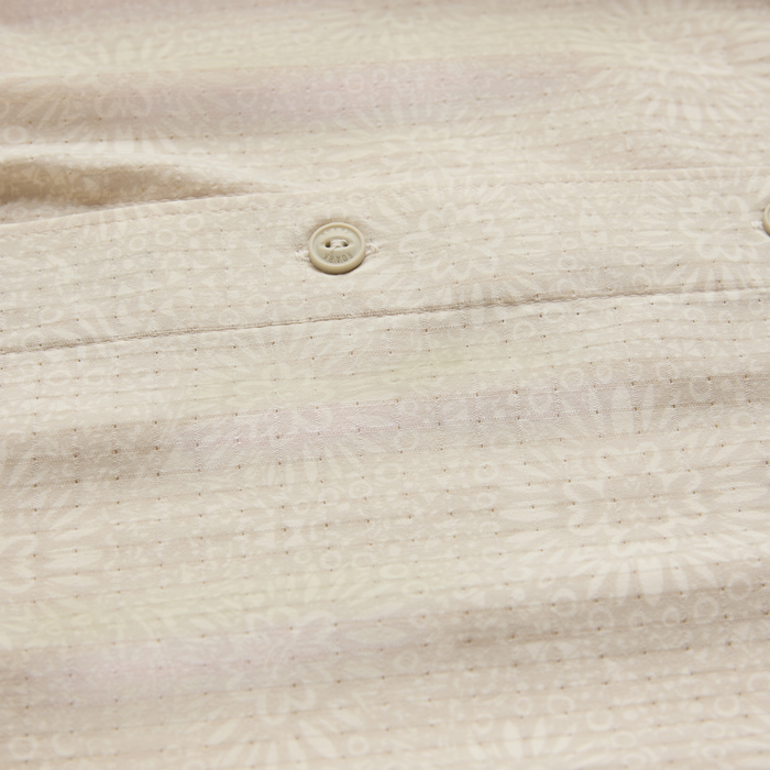 Bless Up Breathable Stretch Shirt in sand with cream button detail on textured fabric, flat lay close-up