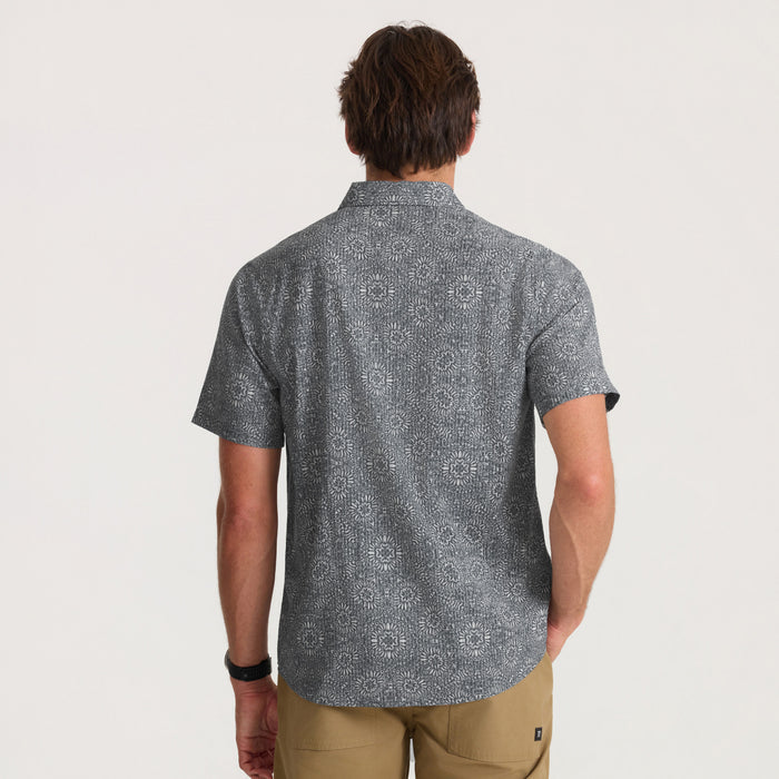 Man wearing Bless Up Breathable Stretch Shirt in slate with geometric pattern, shown from back view on model with khaki pants