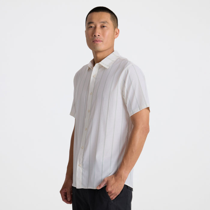 Close-up of a stylish adventure-ready shirt featuring detailed stitching on the collar, buttons, and sleeves, perfect for outdoor exploration.