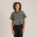 Detail of a black button on a patterned garment, highlighting Roark's focus on quality and adventure-ready apparel.