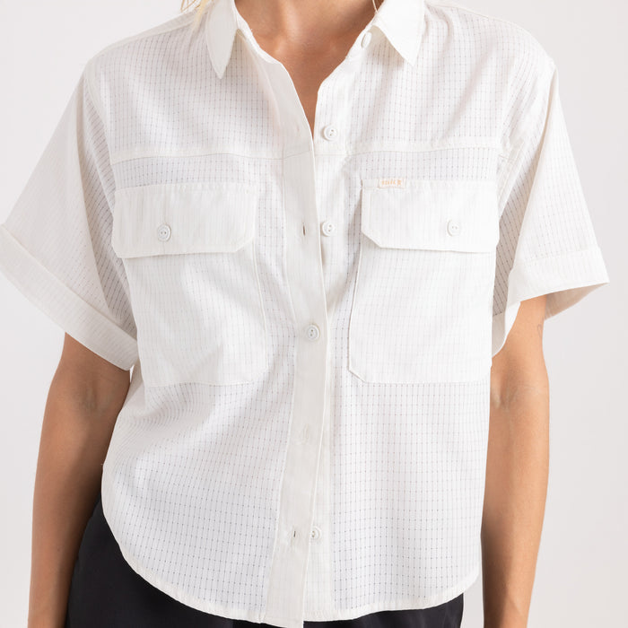 Close-up of a vintage-inspired Roark denim shirt featuring detailed stitching on the sleeve, collar, button, and pocket, perfect for adventure and travel.