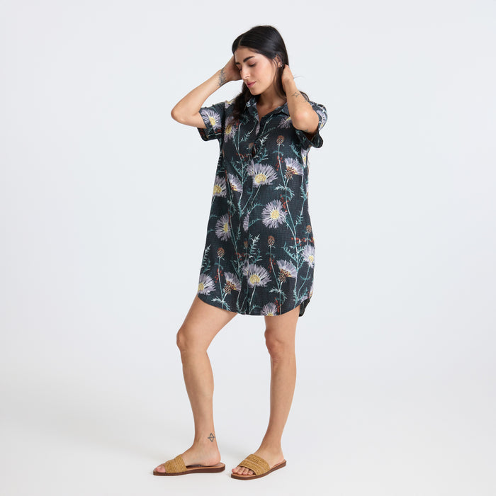 Model wearing an onyx-colored day dress in an adventurous outdoor photo shoot, showcasing Roark’s travel-inspired fashion.