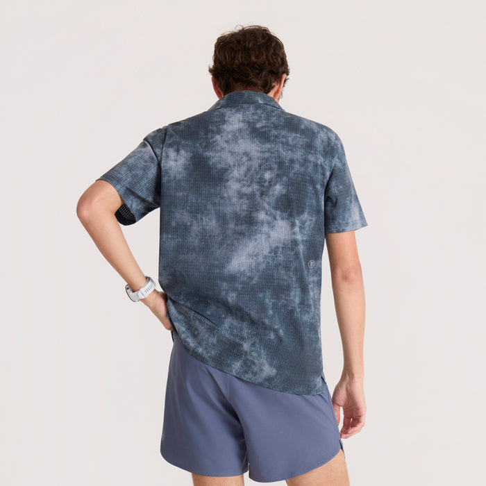 Dark slate tie-dye button-up shirt with ribbed texture, worn by model from back view with hands on hips