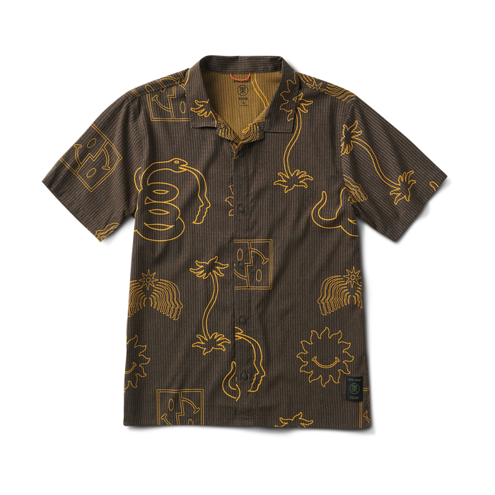 A model wearing Roark Bless Up Trail Button Up Shirt in Kaffa, relaxed style.