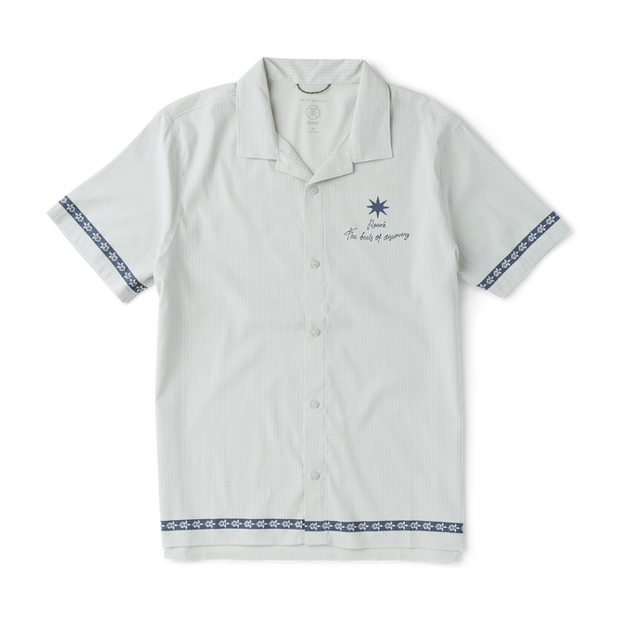Close-up of a versatile Roark silver dress shirt featuring detailed stitching on sleeve, collar, and buttons, ideal for both active and formal occasions.