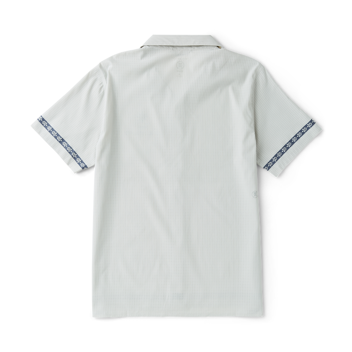 Close-up of a stylish Roark silver active polo shirt detailing the collar, sleeve, and buttons, perfect for outdoor and travel adventures.