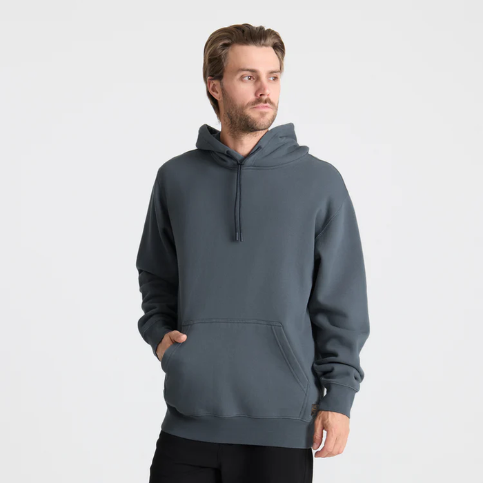 Hooded adventurer facing a scenic landscape, embodying the spirit of outdoor exploration.