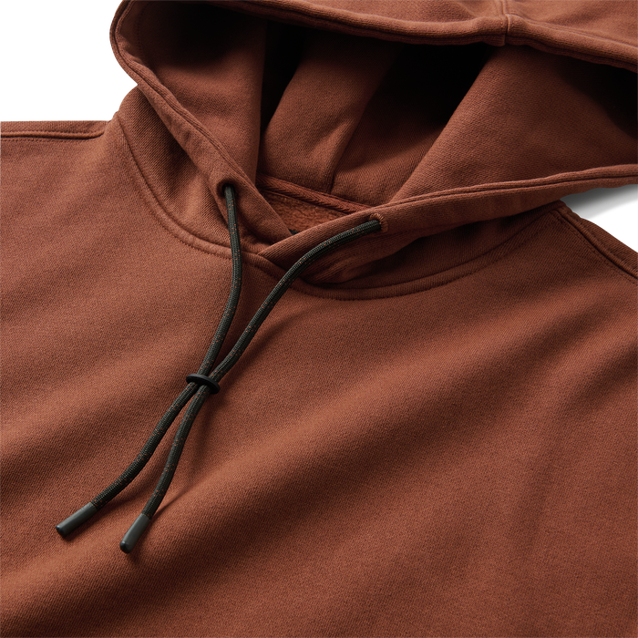 Close-up detail of a Roark adventure hoodie featuring a hood, zipper, and pocket, designed for outdoor exploration and travel.