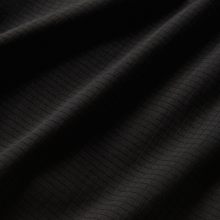 Close-up of the Roark Bommer 3.5" Shorts in Black's fabric, highlighting its durability and easy-care nature.