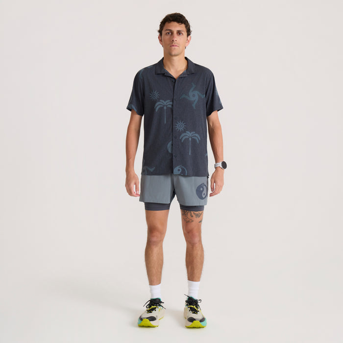 Bommer 3.5" shorts in slate blue worn by model with matching patterned shirt on neutral background