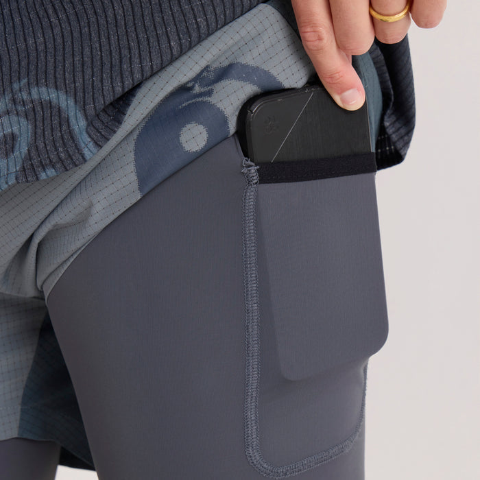 Slate Bommer 3.5" shorts with zippered pocket detail, worn on model with hand inserting black wallet into back pocket