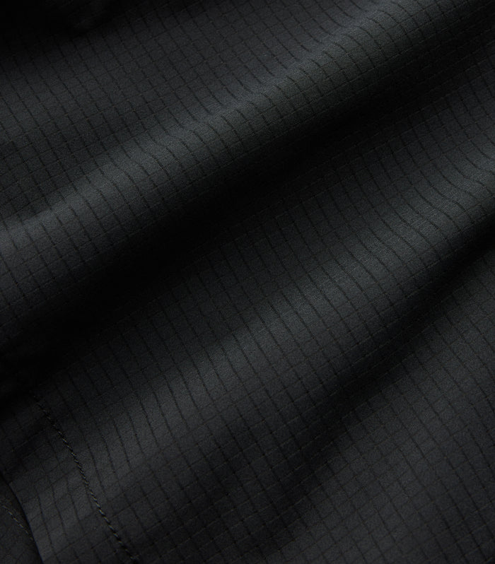 Close-up of textured grey woven fabric, highlighting the fine details and durability suitable for adventure and outdoor gear by Roark.