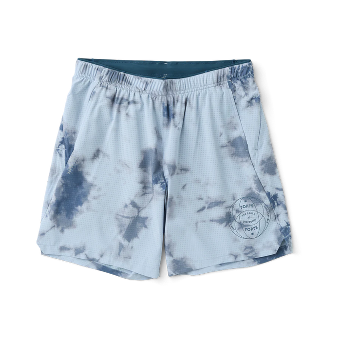 Versatile active wear displayed, featuring white boardshorts and a matching active shirt, perfect for outdoor adventures and travel.