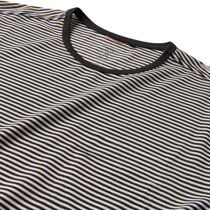 A man wearing the Roark Borrego Short Sleeve Tee in Stripe, demonstrating its versatile style for casual outings and everyday wear.