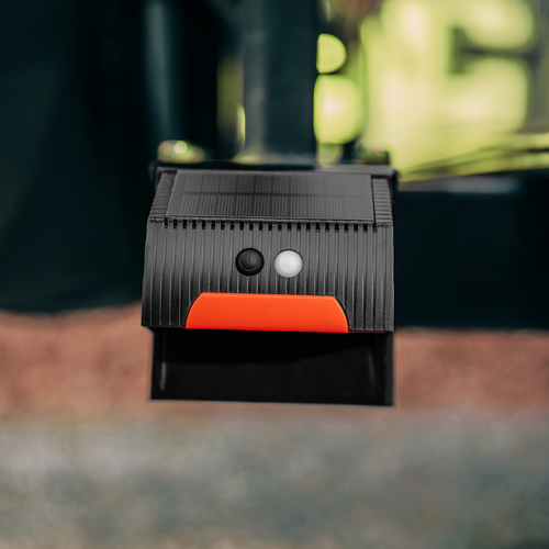 Black Camco 40332 RV Bumper Cap Solar Light with Orange Accent - Lifestyle Angle | United RV Parts