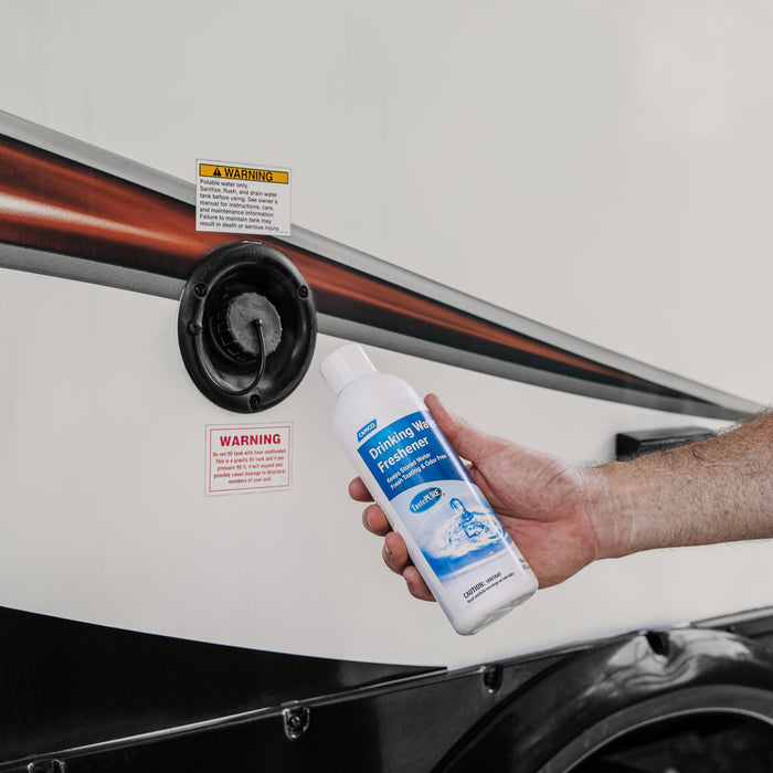 Camco TastePURE Water Freshener Usage - Hand Holding Bottle by RV Water Port | United RV Parts