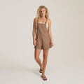 Mocha Canyon Romper with adjustable straps and button detail, worn on model with black sandals against neutral background