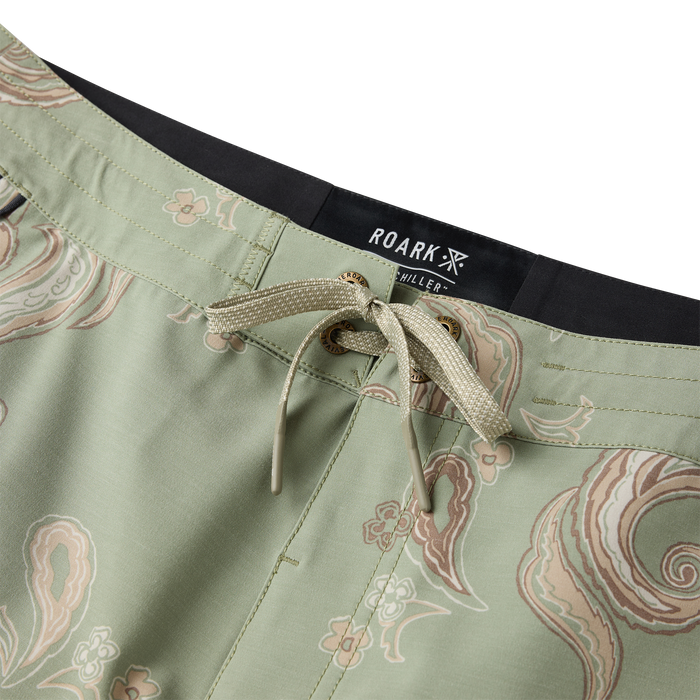 Roark Chiller Scallop boardshorts in dusty sage with ornate paisley print and drawstring waistband, close-up detail view
