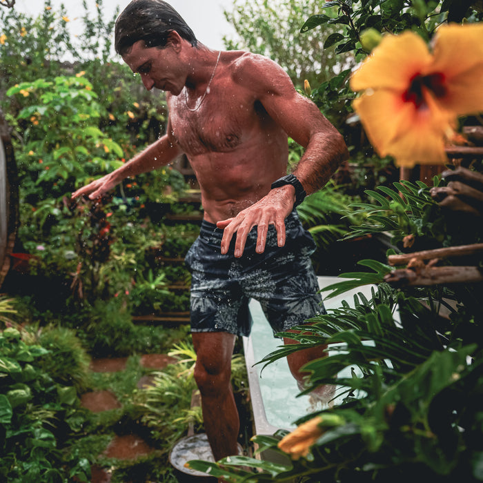 Active man showcasing athletic muscle while wearing Roark's versatile boardshorts, ideal for adventurous outdoor activities.