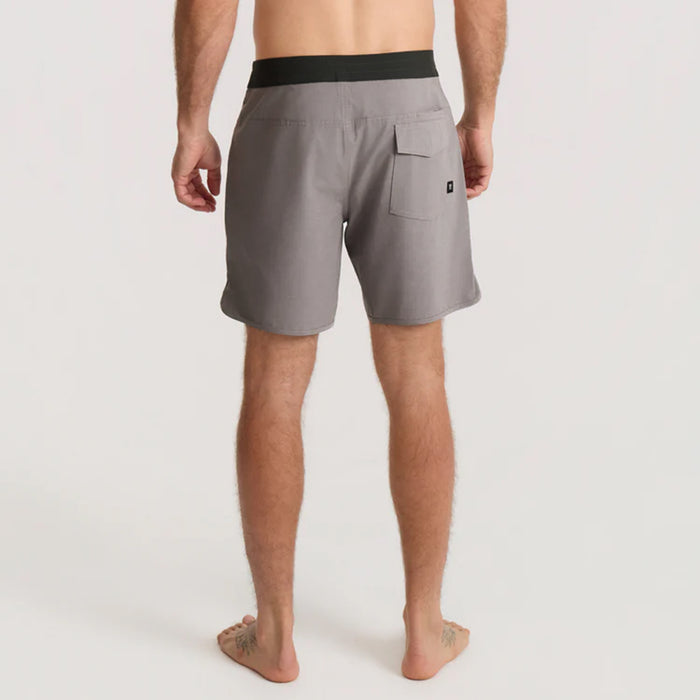 Man wearing boardshorts stands in the breathtaking Lake District, embodying the spirit of outdoor adventure and freedom.