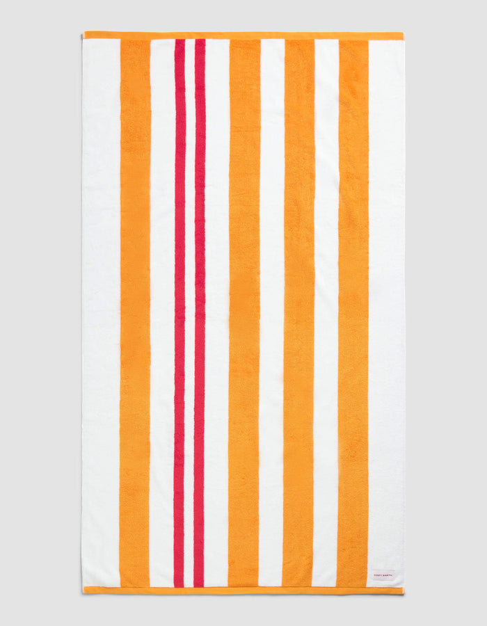 The Cozy Earth Classic Stripe Resort Towel in Picante Stripe features a rectangular design with vertical orange, red, and white stripes—wide orange and white bands paired with two narrower red stripes near the left edge.|Color:Picante Stripe
