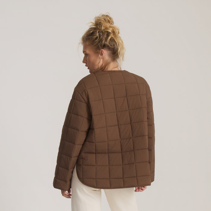 Cloud Liner Jacket in coco bean brown with quilted pattern, shown from back on model wearing cream pants