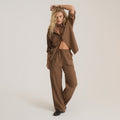 Brown textured button-up shirt worn open over matching wide-leg pants on model against neutral background