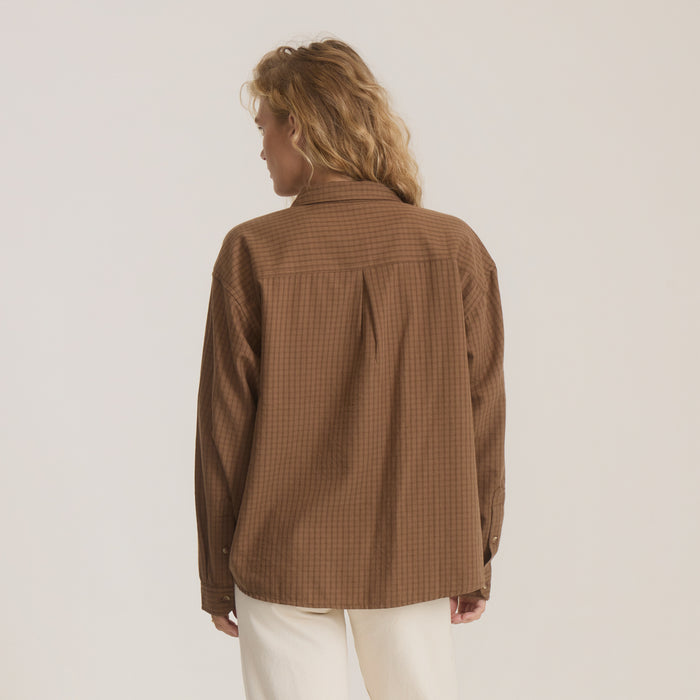 Woman wearing brown Costa Shirt button-up with coco bean color and textured pattern, shown from back view against neutral background