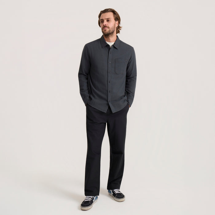 Crossroads organic cotton flannel shirt in dark charcoal worn by male model with black pants and sneakers
