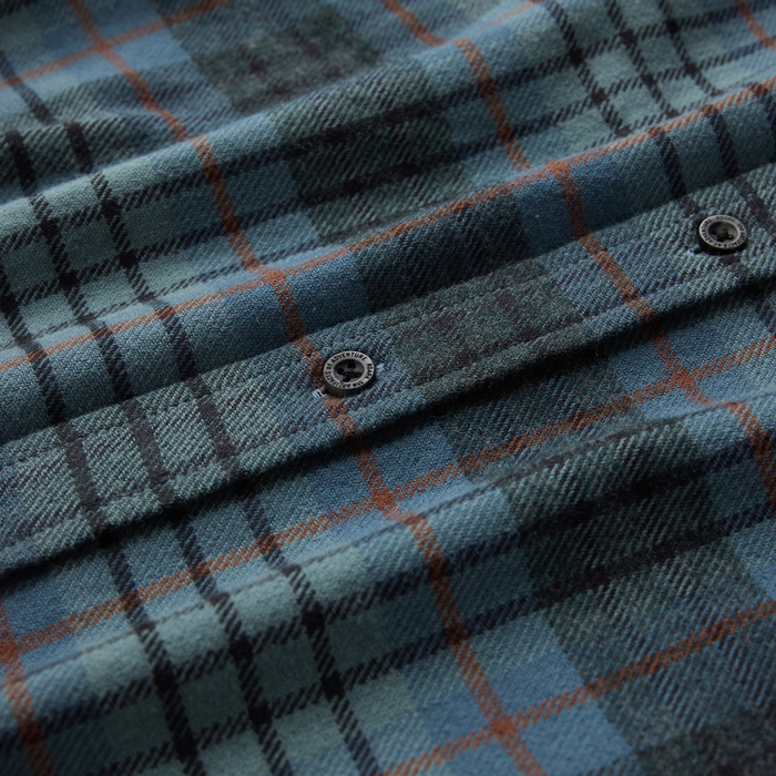 Crossroads Organic Cotton Flannel shirt in dark slate with rust plaid pattern, close-up detail shot showing textured weave and snap buttons