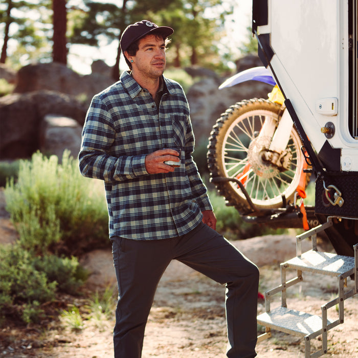 Group of friends enjoying a leisurely outdoor adventure, wearing Roark's Crossroads Organic Cotton Flannel shirts in a picturesque natural setting