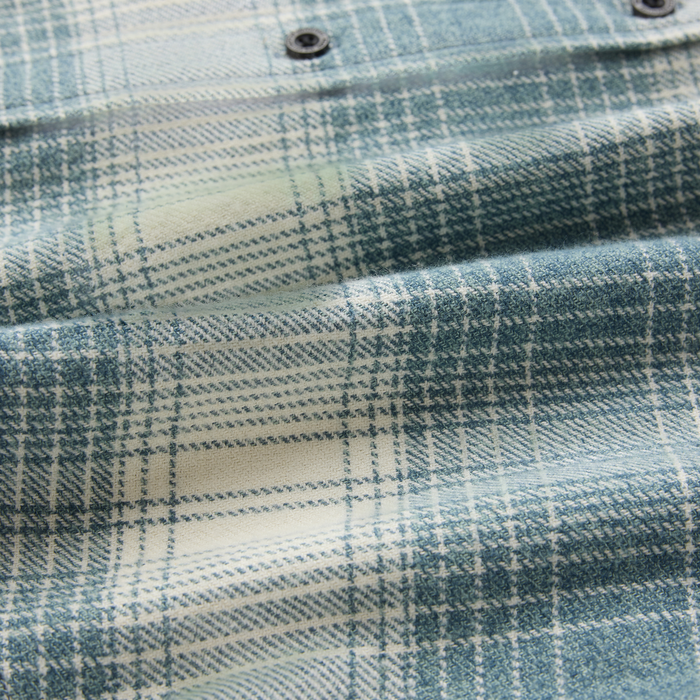 Crossroads organic cotton flannel in hazy blue with cream plaid pattern, close-up detail of woven texture and fabric weave