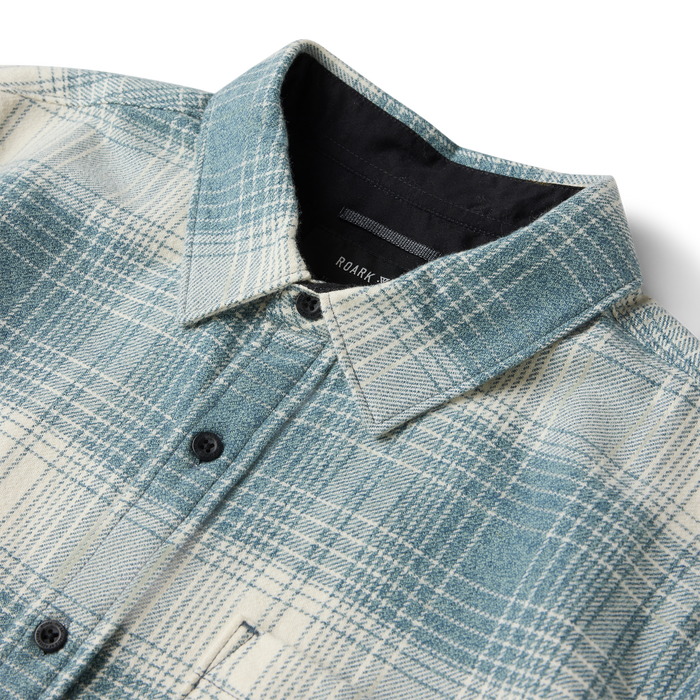 Crossroads organic cotton flannel shirt in hazy blue plaid with black buttons, shown flat lay detail at collar