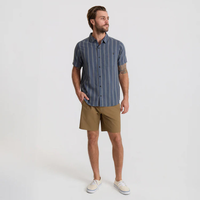 Close-up of Roark adventure-ready Bermuda shorts featuring buttons and pockets, perfect for travel and outdoor activities.