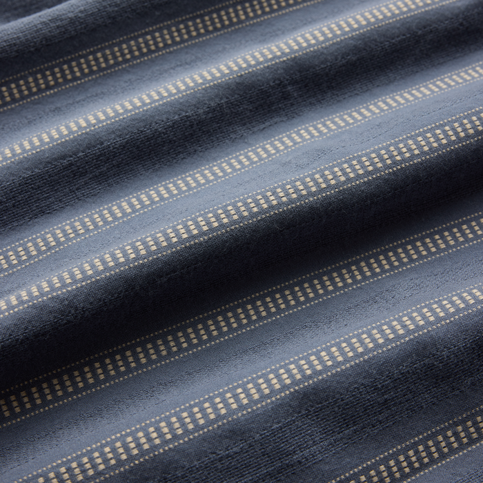 Close-up texture of grey denim woven fabric, highlighting the intricate weaving detail, perfect for Roark's adventure and travel gear.