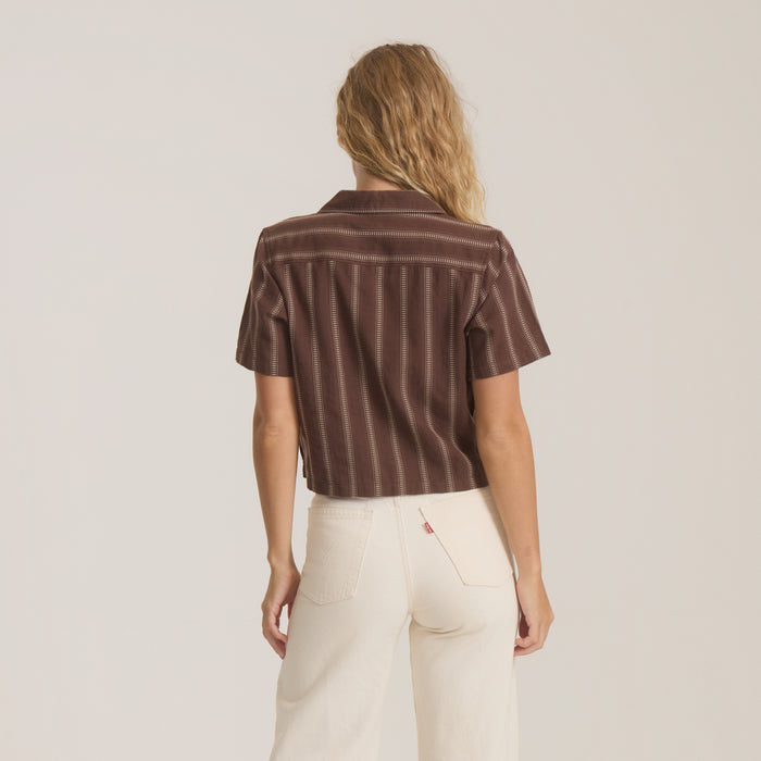 Brown striped camp shirt with short sleeves worn on model from behind, paired with cream jeans