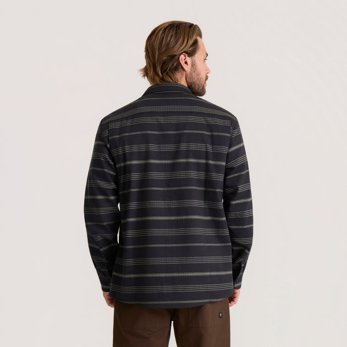 Man wearing black striped Diablo long sleeve flannel shirt, shown from back view against neutral background