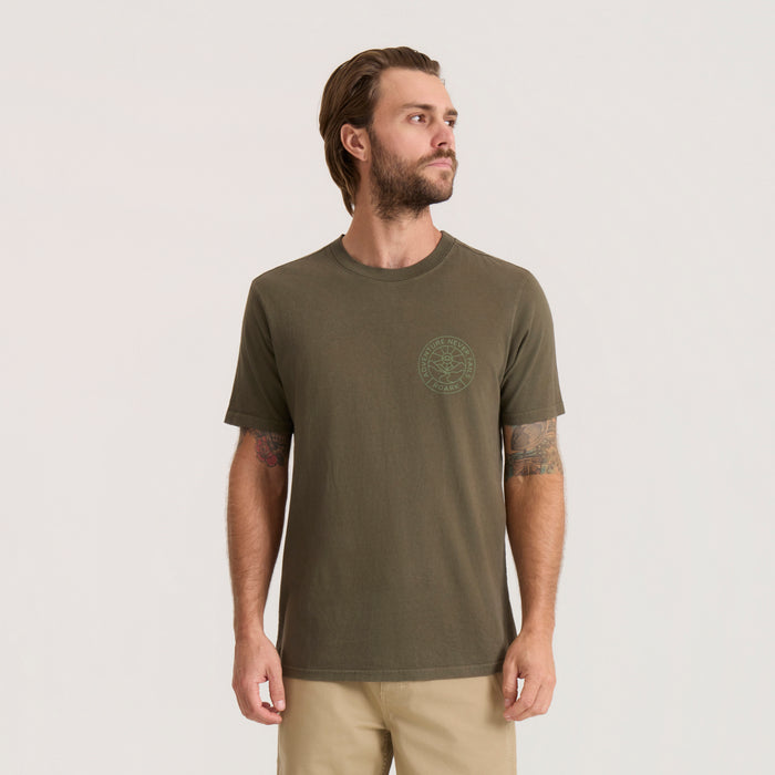 Olive green Division Premium Tee with circular logo graphic on chest, worn by man against neutral background