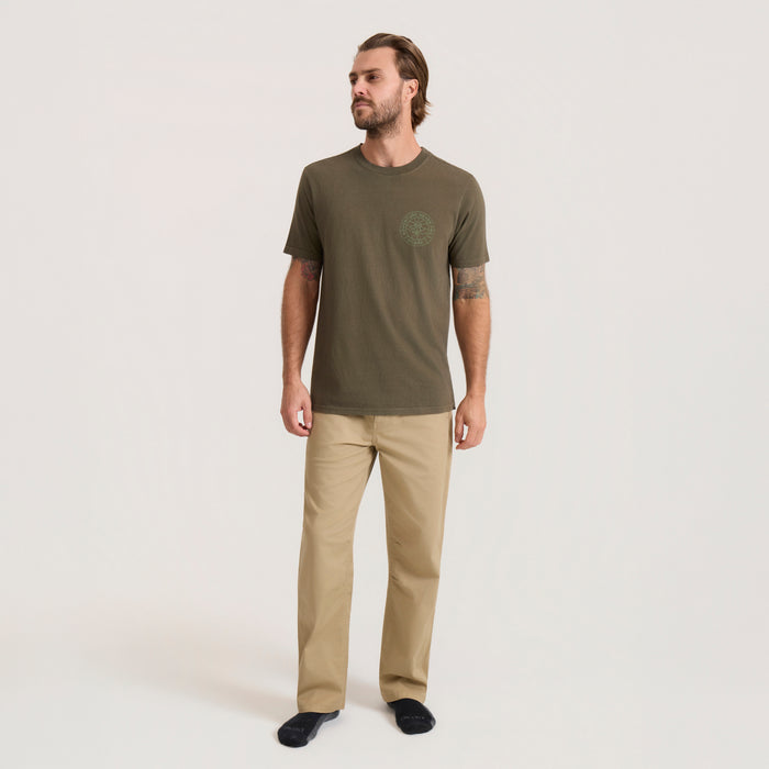 Military green Division Premium Tee worn by male model with khaki pants, small circular logo on chest