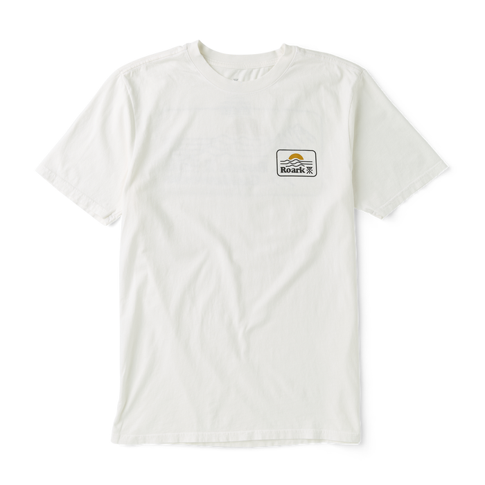 Detail view of a Roark active shirt sleeve with visible label, designed for adventure and travel.
