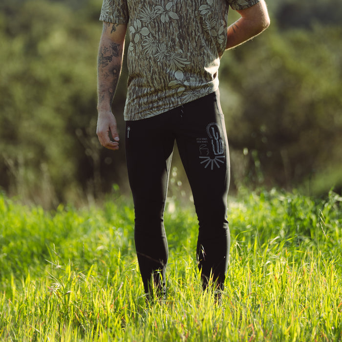 Person wearing sporty active pants and sleeveless top, poised in a dynamic outdoor setting, embodying Roark's adventurous spirit