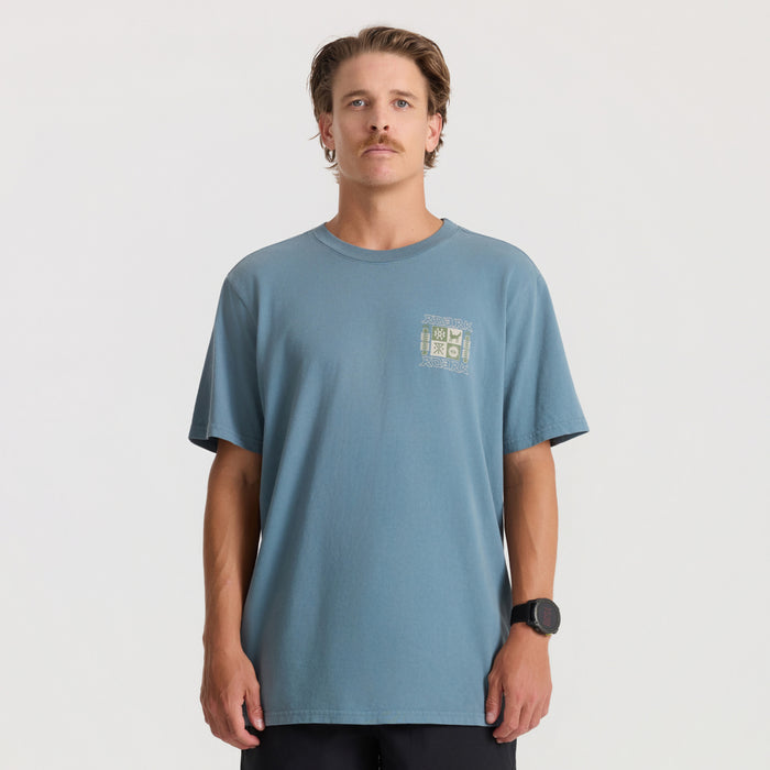 Slate blue short sleeve t-shirt with embroidered graphic on chest, worn by man against neutral background