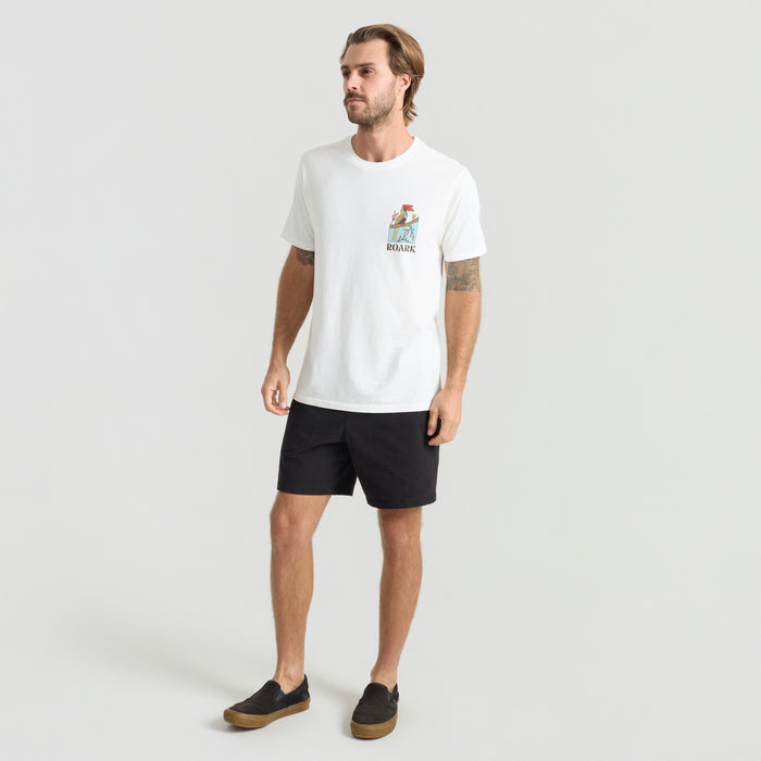 Man wearing versatile active shirt and Bermuda shorts, ideal for outdoor adventure and travel, showcasing comfort and durability.