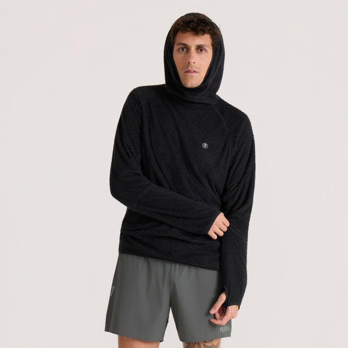 Black Evolve hoodie worn by model with hood up, paired with gray shorts on neutral background
