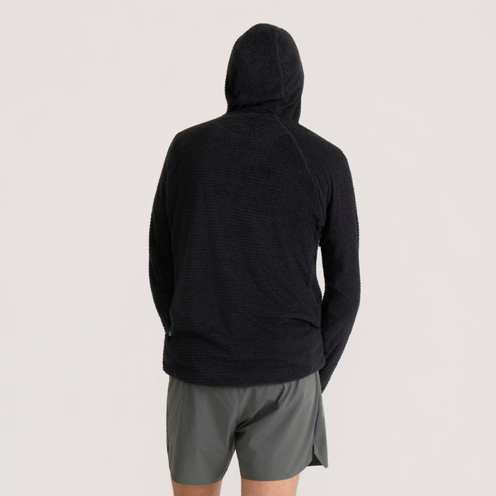Black Evolve hoodie worn by model from behind, showing textured knit fabric and hood detail