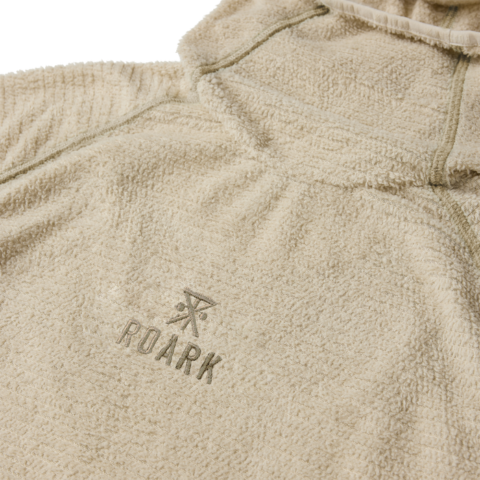 Beige Roark Evolve Hoodie with textured fabric and embroidered logo, flat lay detail shot