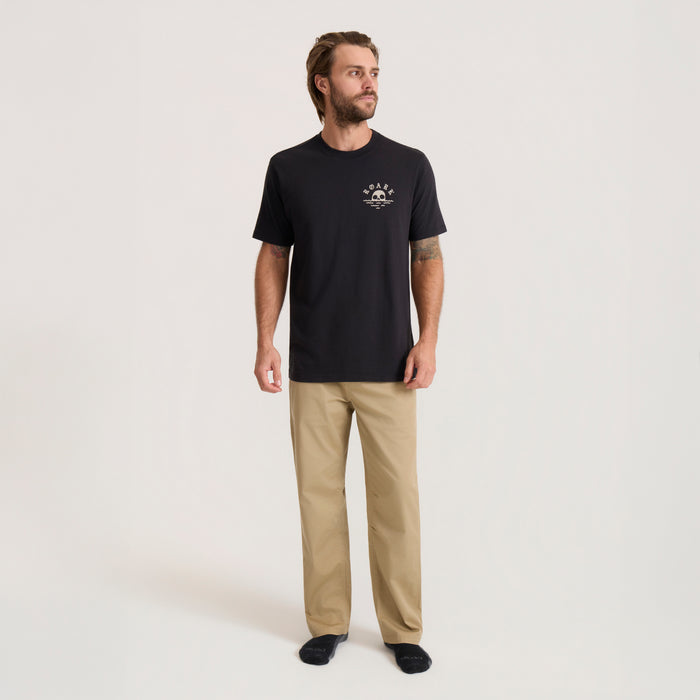 Black Fear The Sea Premium Tee with small chest graphic worn by man standing against neutral background