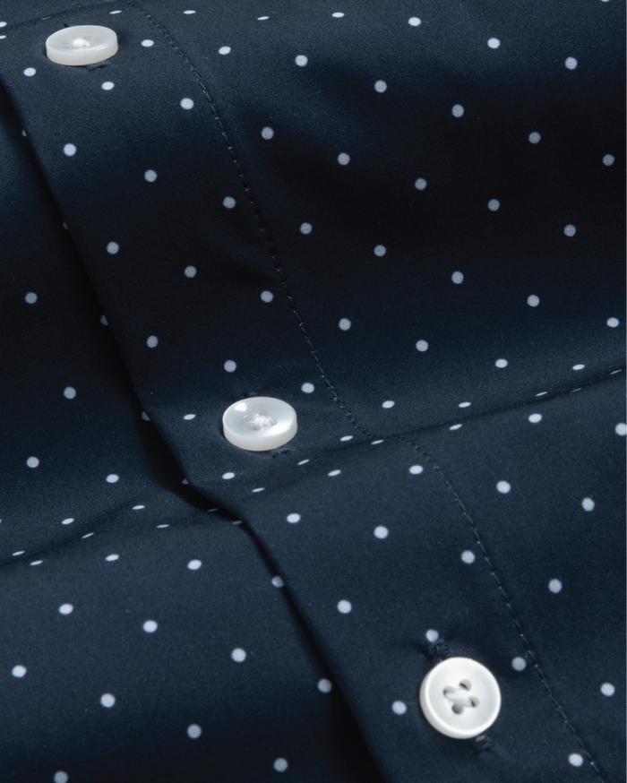 Close up of navy shirt with white polka dots