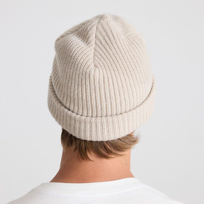 Warm and cozy woolen beanie, perfect for outdoor adventures and chilly travels, displayed in a natural setting.